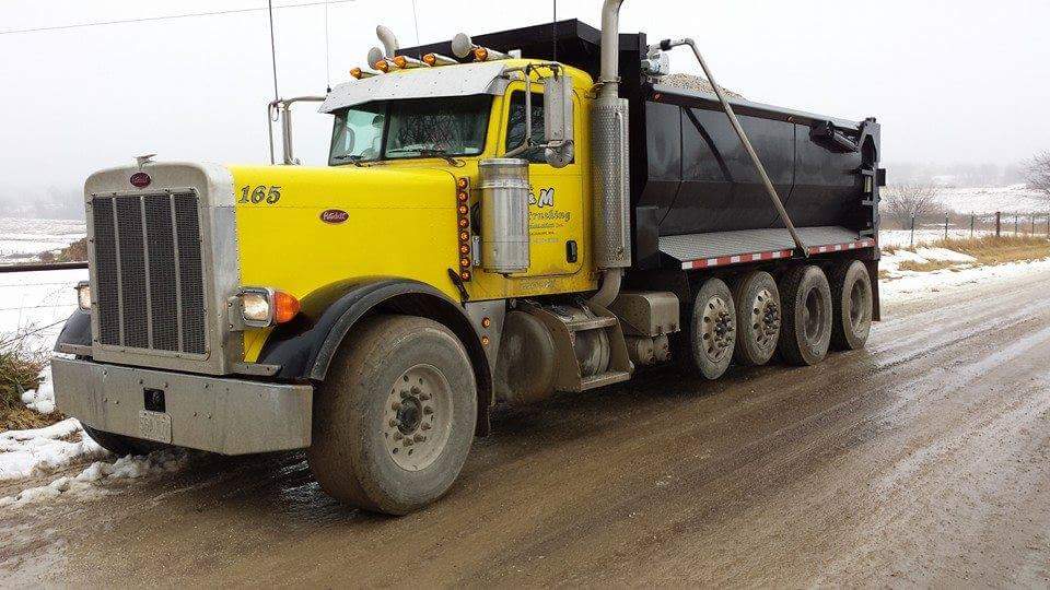 Spreading gravel on muddy roads